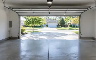 Empty two-car residential garage interior with concrete floor and open double door