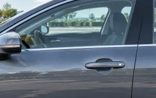 A closed driver door with the outside handle at rest and the glass fully up