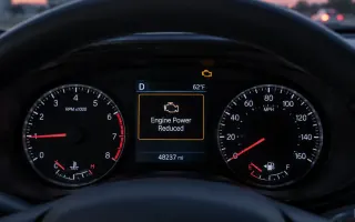 Driver view of a U.S. car instrument cluster showing an Engine Power Reduced warning on the display